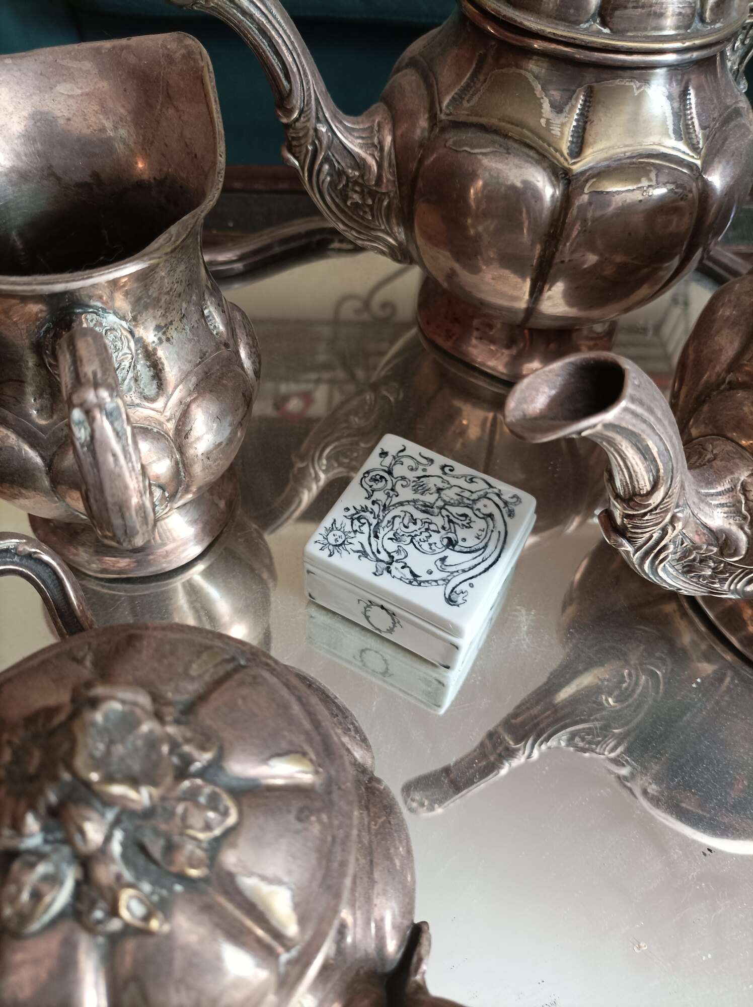 Porcelain box among silverware