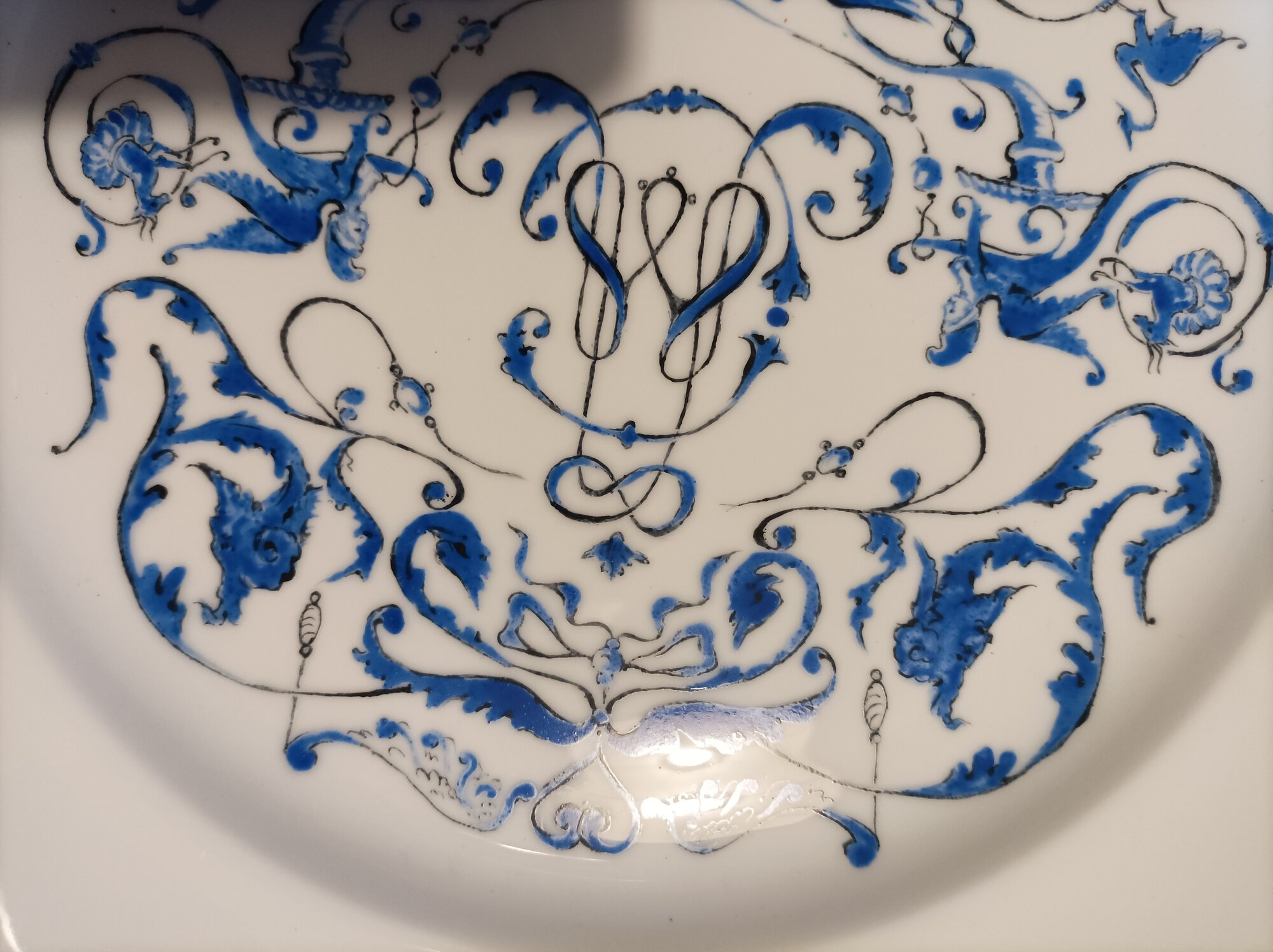 Large porcelain plate painted in blue, detail