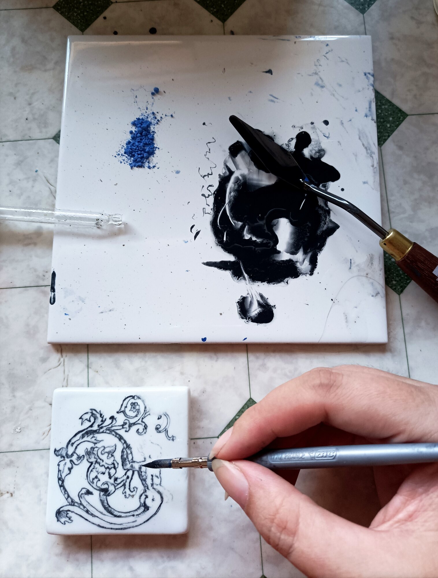 K. Lious painting a porcelain box