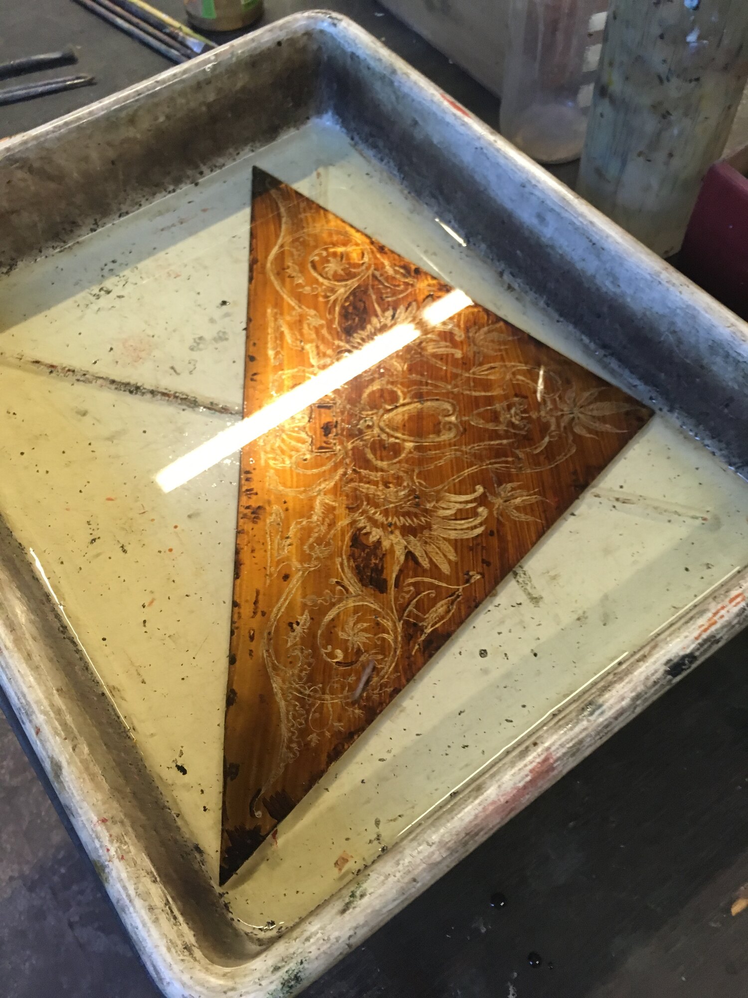 An etching plate in the bath